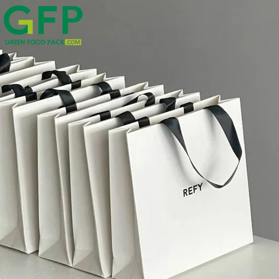 Bolsa de papel de lujo con logotipo personalizado ODM OEM para compras, embalaje de ropa, regalo y asa troquelada.